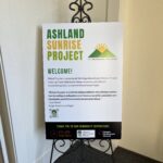 A promotional display board for the ashland sunrise project welcoming guests and acknowledging community supporters.