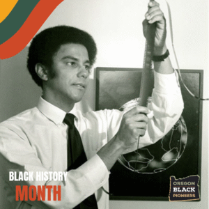 A man in a dress shirt and tie examines a reel of film. Behind him is a globe illustration. 